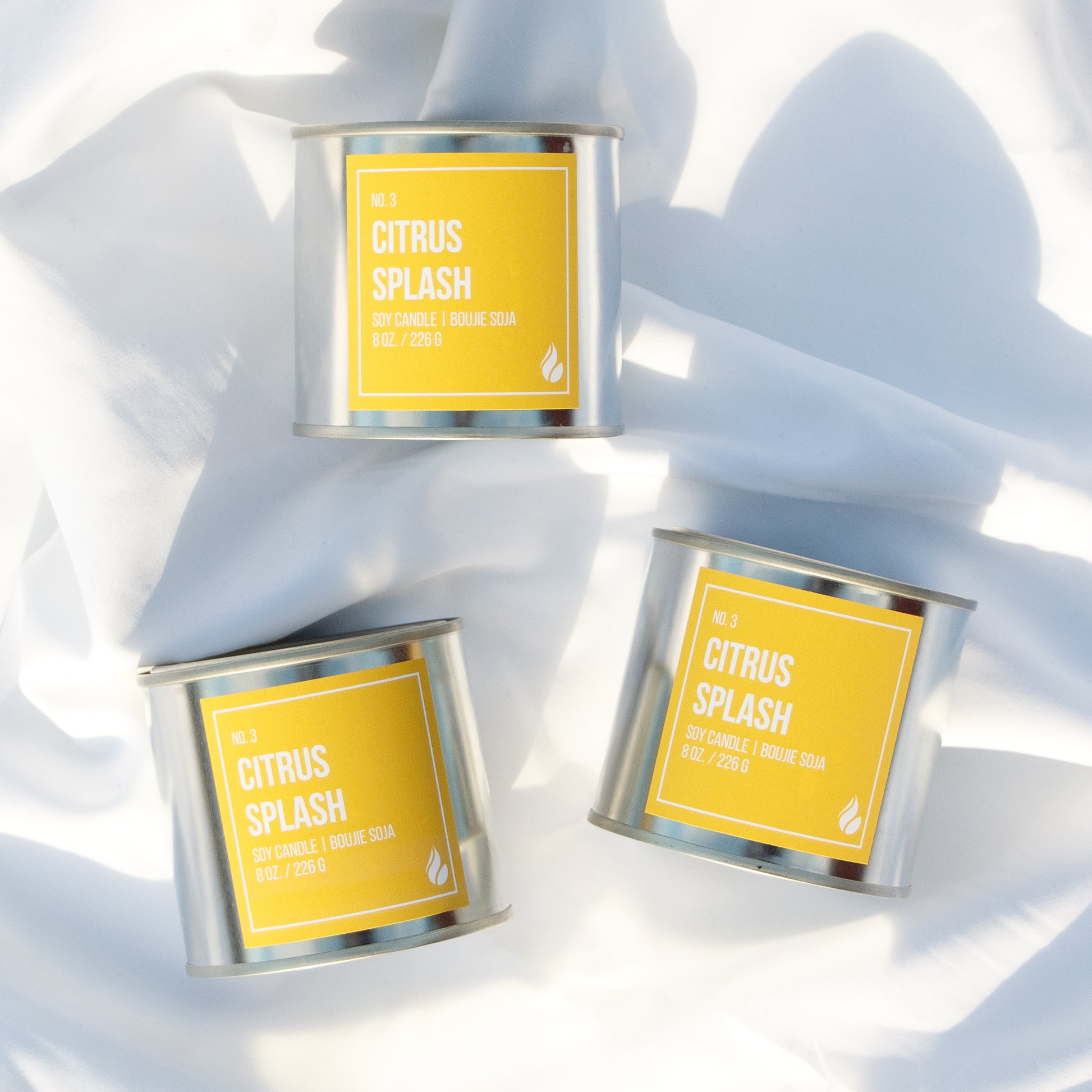 Three 'Citrus Splash' candles on a white background