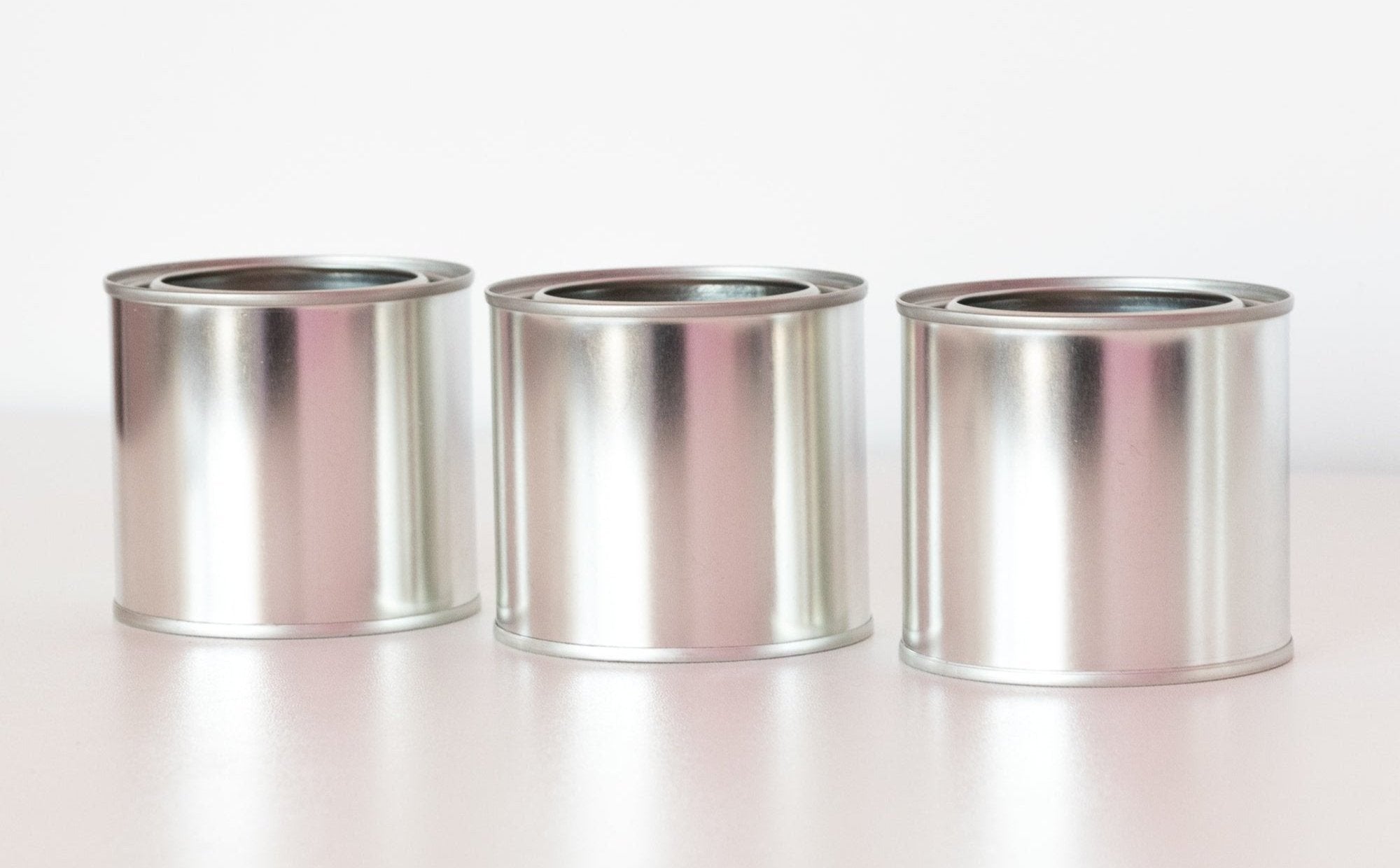 Picture of three unlabeled paint can vessels side-by-side.