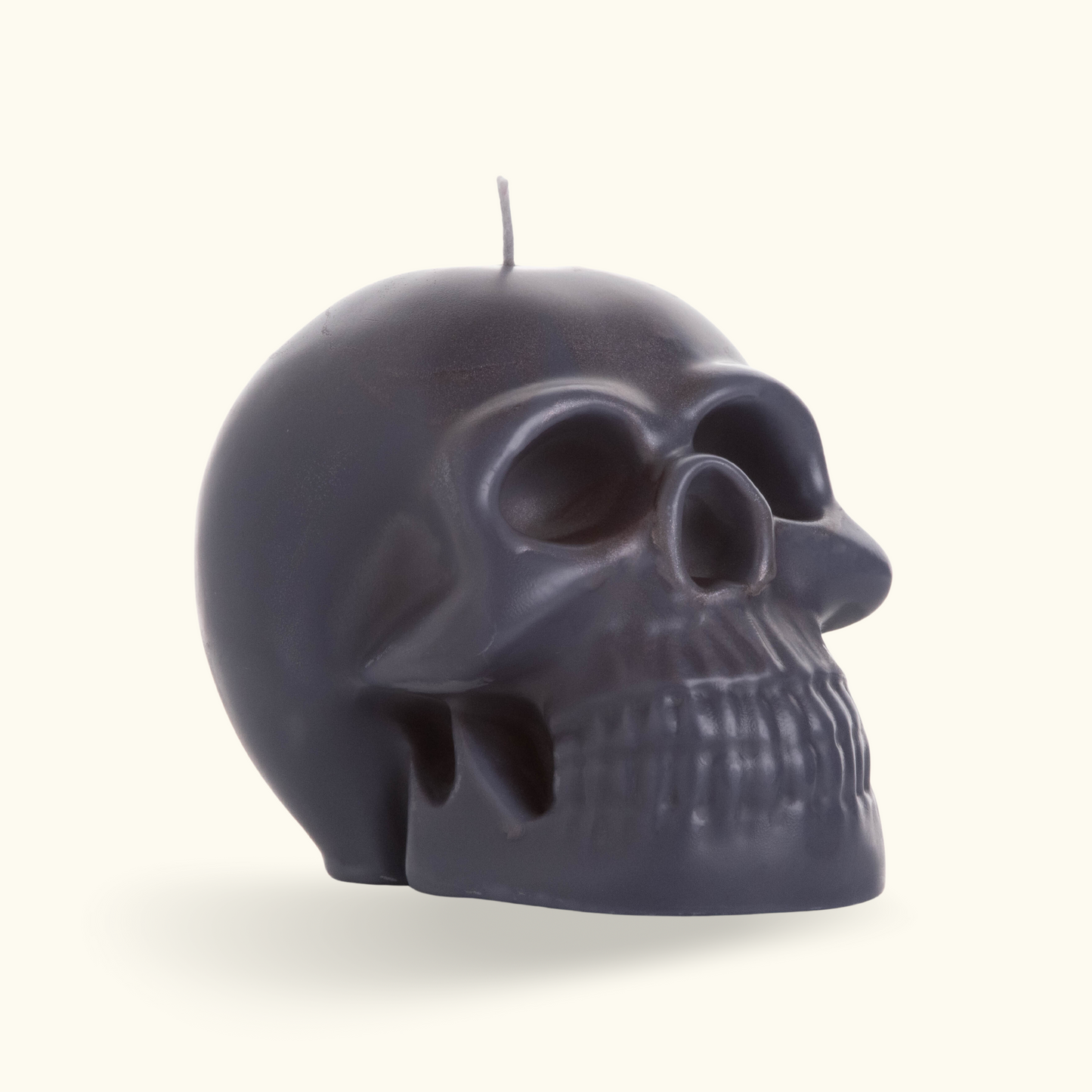 Picture of a black skull candle with a cotton wick.