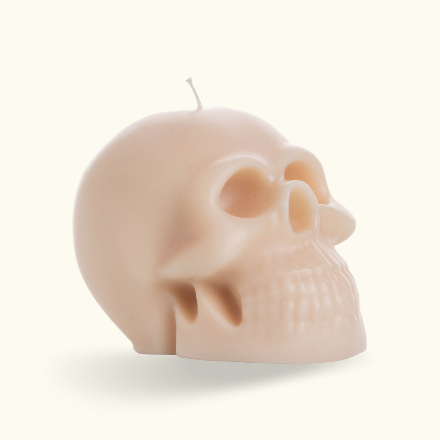 Picture of a white skull candle with a cotton wick.