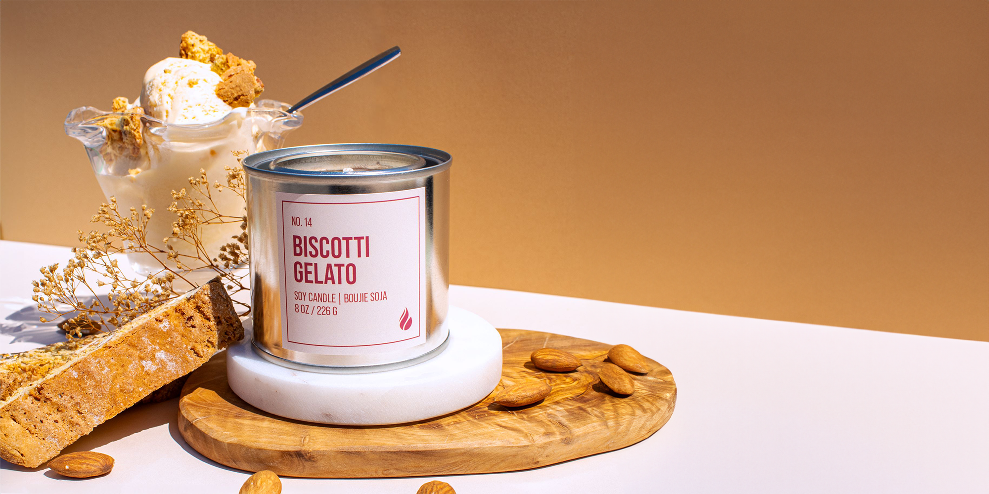 Product photography of Biscotti Gelato featuring a glass of gelato, biscotti and almonds as props.